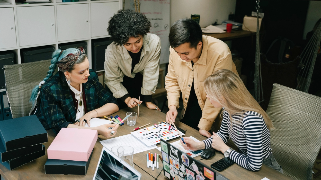 Creative team collaborating on brand strategy and color direction before a rebrand